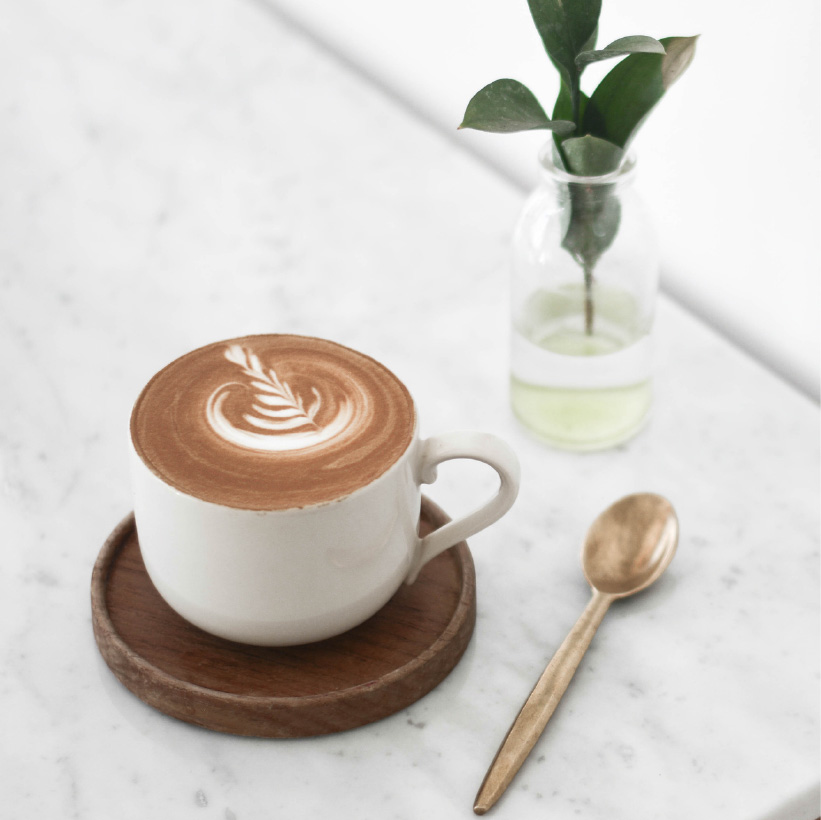 White ceramic cup fIlled with capuccino
